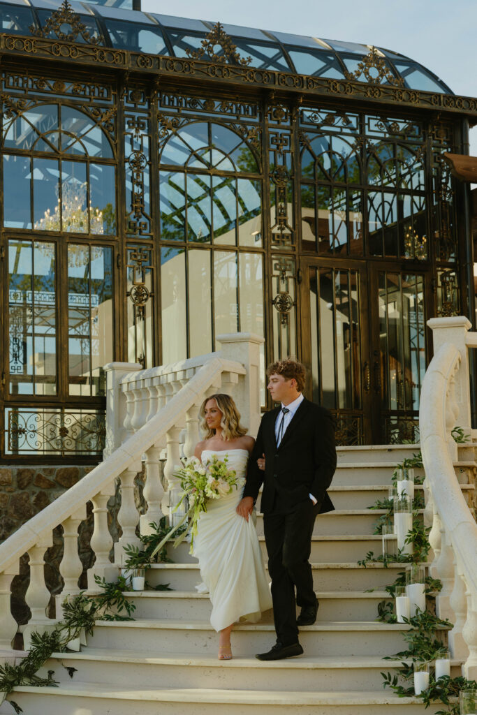 editorial pose bride and groom on marble staircase on wedding day 