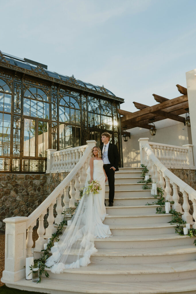 bride and groom on marble staircase 