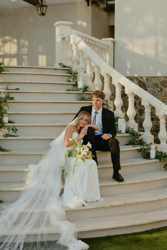 editorial pose bride and groom on marble staircase on wedding day 