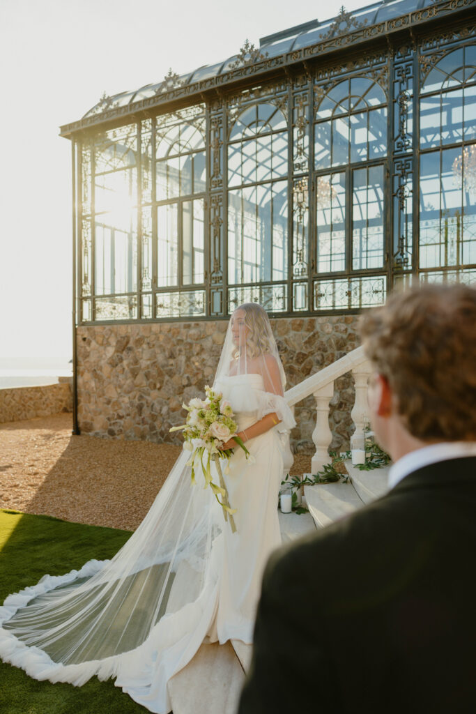 editorial pose bride and groom on marble staircase on wedding day 