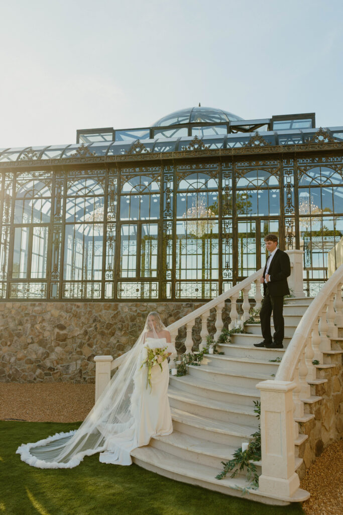 editorial pose bride and groom on marble staircase on wedding day 