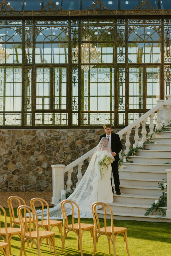 editorial pose bride and groom on marble staircase on wedding day 