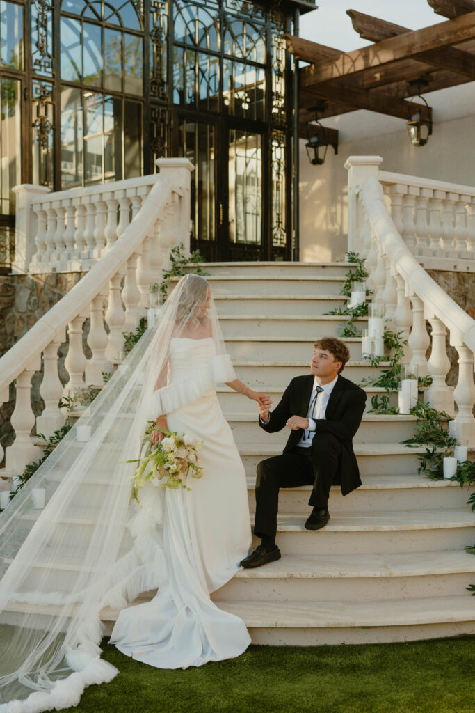 editorial pose bride and groom on marble staircase on wedding day 