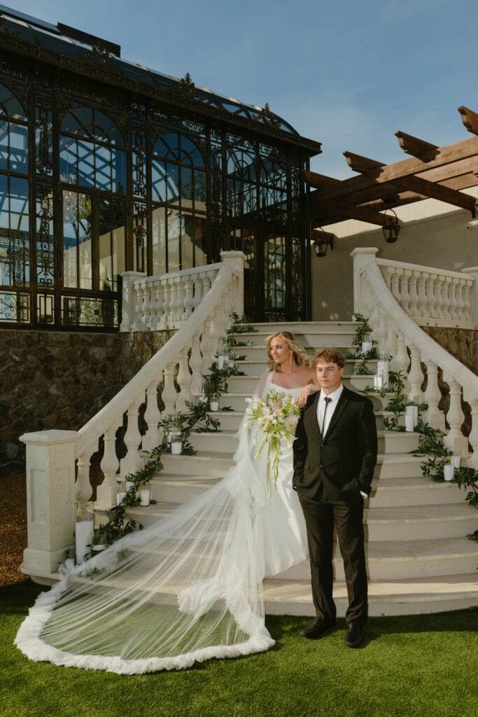 editorial pose bride and groom on marble staircase on wedding day 