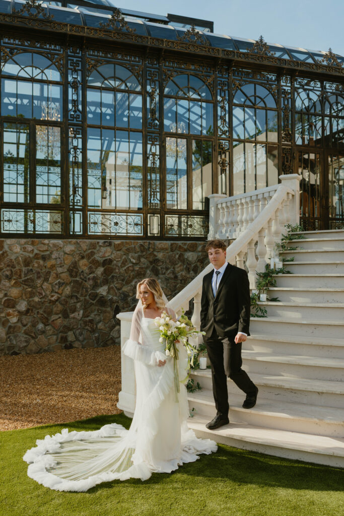 editorial pose bride and groom on marble staircase on wedding day 