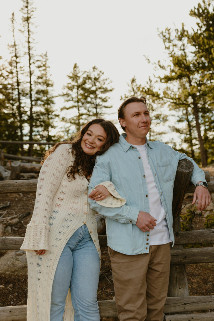 woman smiling and leaning on mans shoulder during engagement session