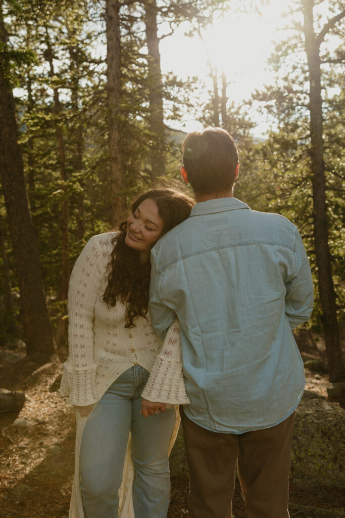 woman leaning on mans shoulder laughing