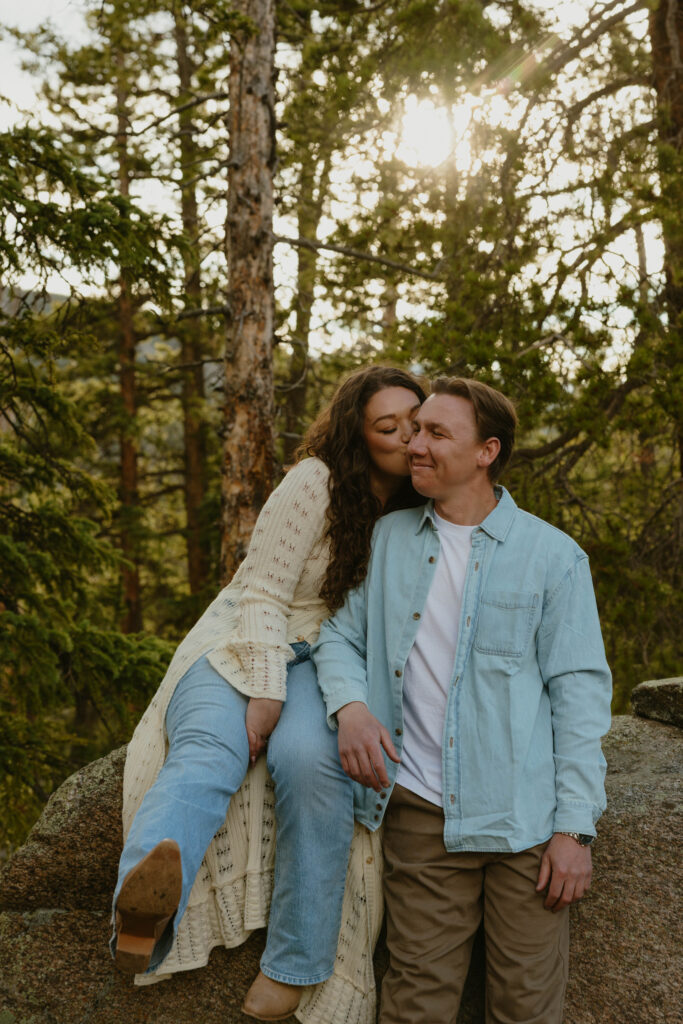 woman kissing mans cheek engagement session