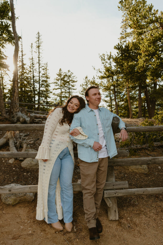 man and woman smiling and standing together during engagement session