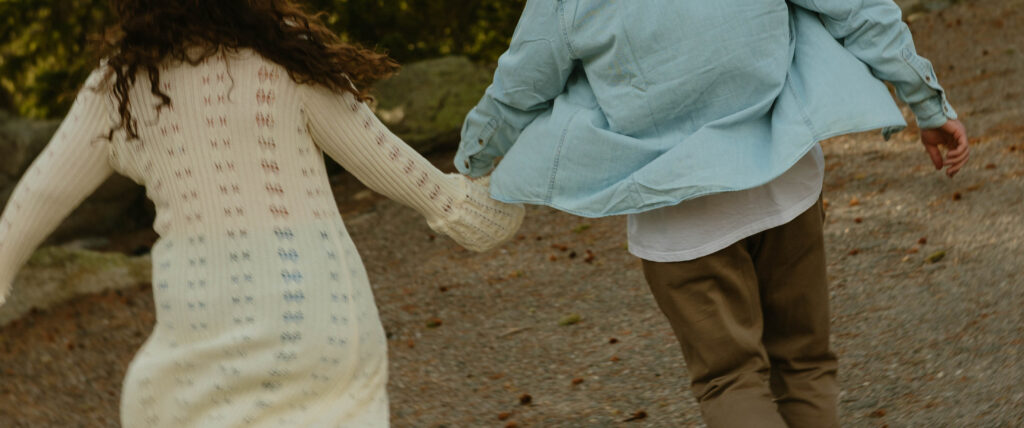 detail of man and woman holding hands