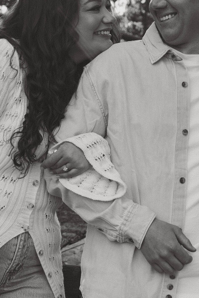 detail photo of smiles and engagement ring