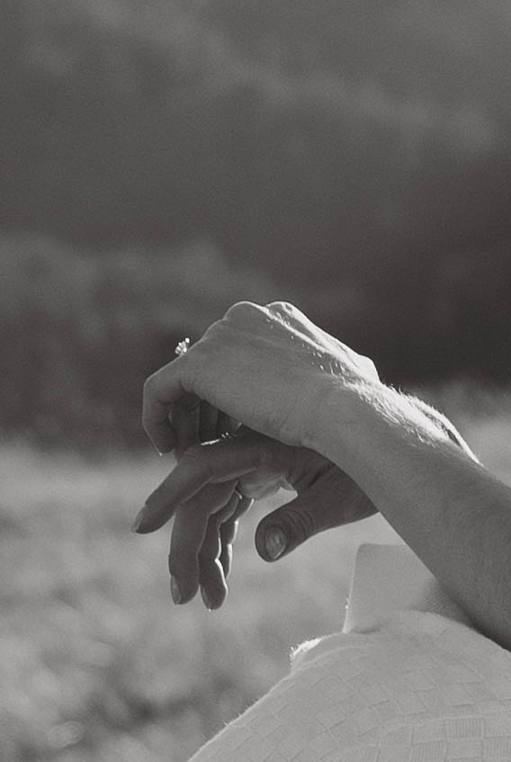 Couple twirling in the mountains during engagement photos