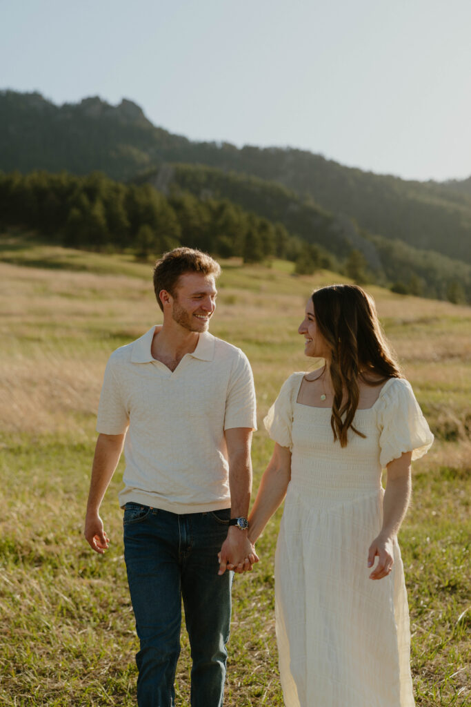 Couple holding hands walking during Colorado engagement session