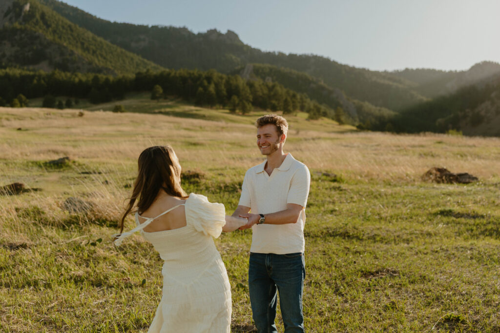 Playful engagement session in Colorado meadow