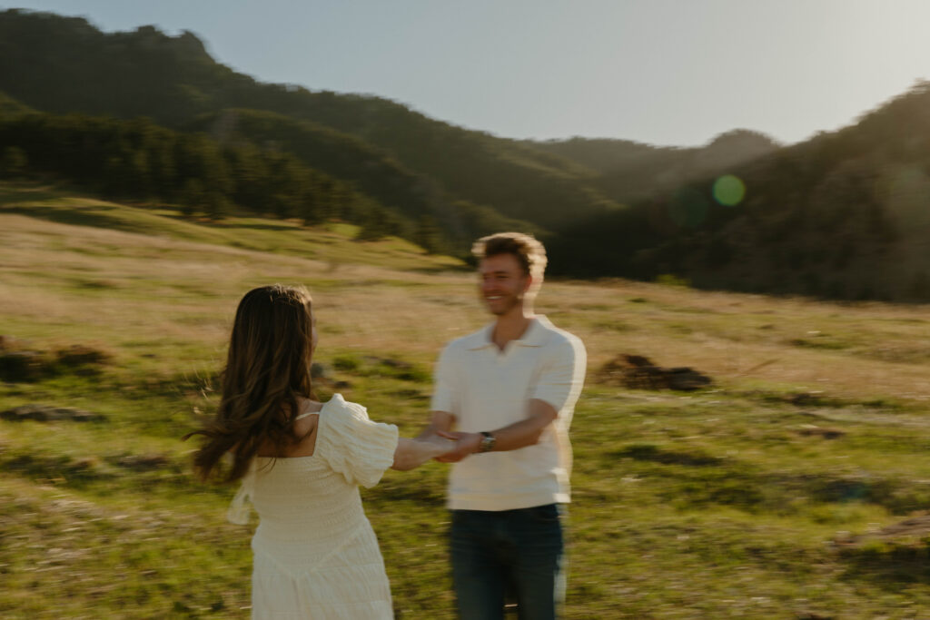 Playful engagement session in Colorado meadow