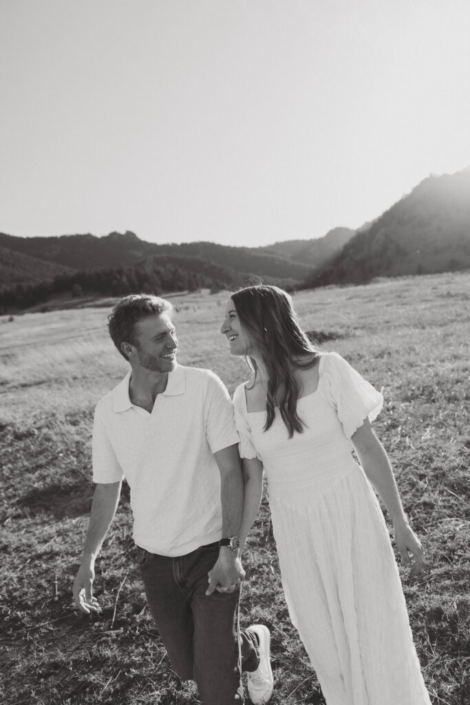 Couple holding hands walking during Colorado engagement session