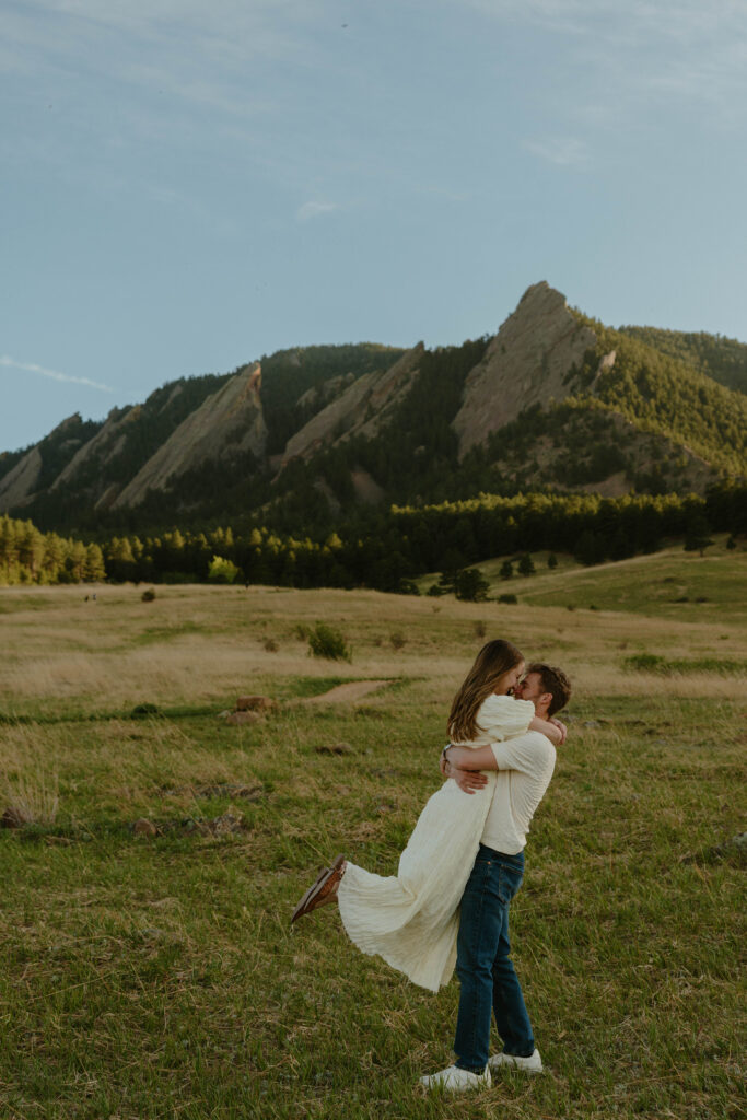 Playful engagement session in Colorado meadow