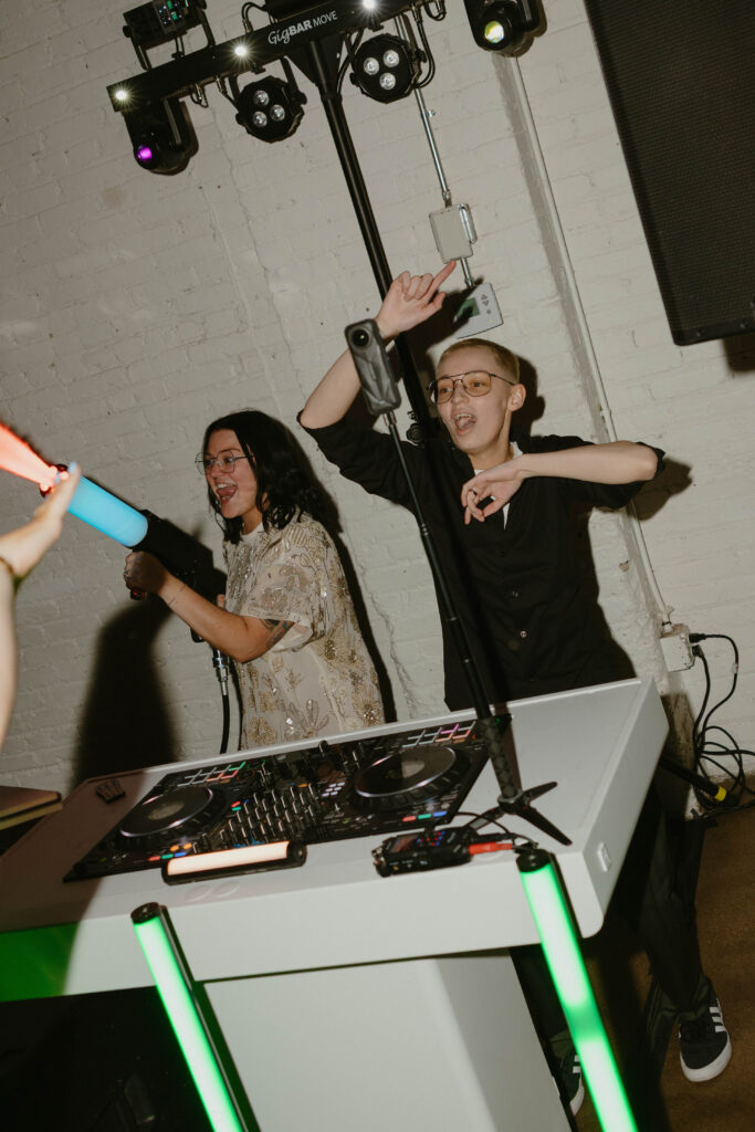 two brides at their wedding reception partying 