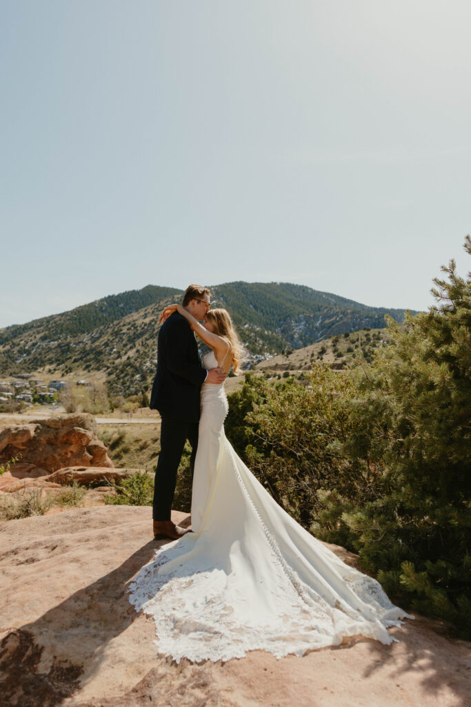 groom kissing brides forehead on wedding day. wedding day sneak peeks
