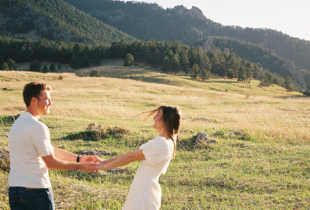 Playful engagement session in Colorado meadow