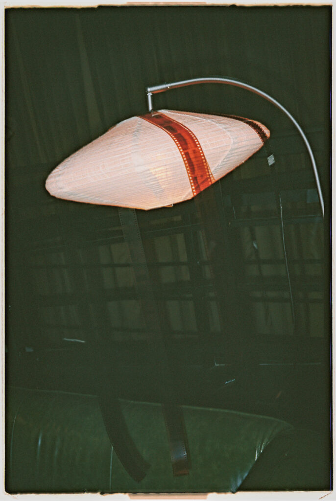 film negatives on lamp, wedding photographer details